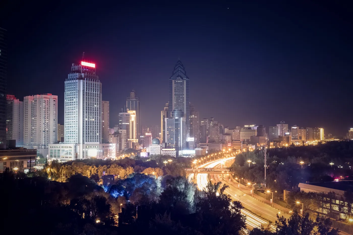 The avenue and towers of Urumqi, capital of Xinjiang, at night