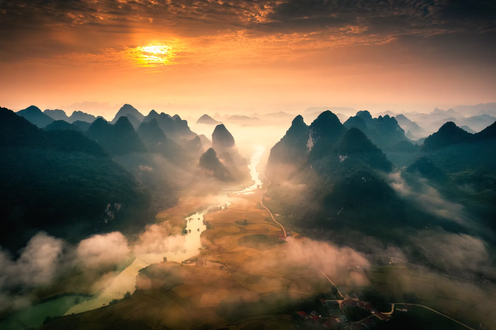 Mist over the river and the karst peaks at sunset